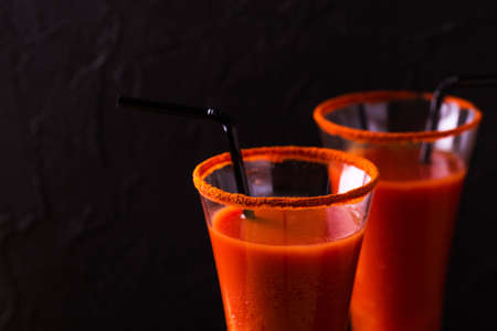 Bloody Mary cocktail with spicy smoked ground chili pepper, ice and celery.の写真素材