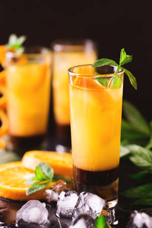 Aperitif with vodka, orange juice, chocolate and mint. Selective focus. Screwdriver short cocktail drink. Summer refreshmentの写真素材