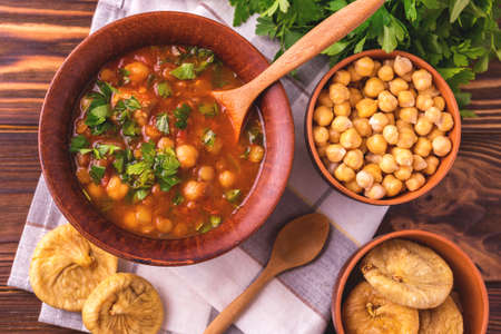 Traditional Maghreb, Moroccan and Algerian tomato soup Harira and ingredients. Served with figs. Ramadan food. Traditional Jewish cuisineの写真素材