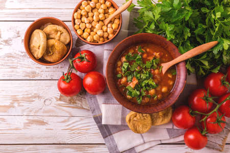 Traditional Maghreb, Moroccan and Algerian tomato soup Harira and ingredients. Served with figs. Ramadan food. Traditional Jewish cuisineの写真素材
