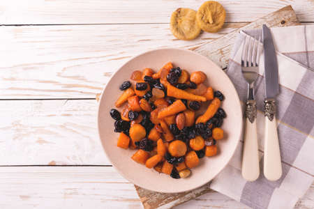 Traditional Jewish Tzimmes dessert with carrot, raisins and dried fruits on table. Top view. Israeli cuisineの写真素材