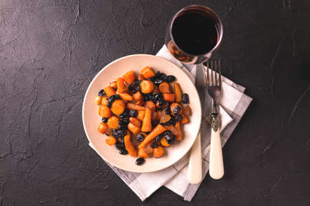 Traditional Jewish Tzimmes dessert with carrot, raisins and dried fruits on table. Top view. Israeli cuisineの写真素材