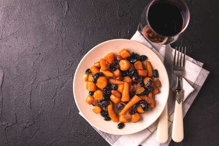 Traditional Jewish Tzimmes dessert with carrot, raisins and dried fruits on table. Top view. Israeli cuisineの写真素材
