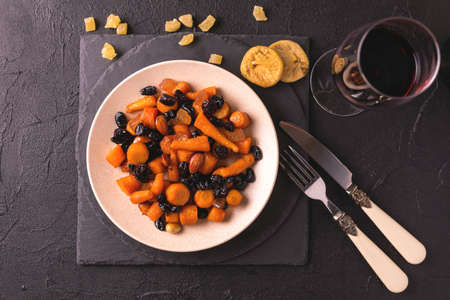 Traditional Jewish Tzimmes dessert with carrot, raisins and dried fruits on table. Top view. Israeli cuisineの写真素材