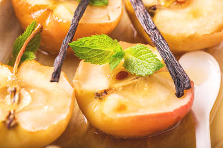 Homemade baked red apples with vanilla syrop, mint and honey. Close up. Top viewの写真素材