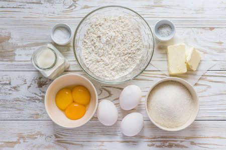 Ingredients for baking muffins on white wooden table, close-upの写真素材