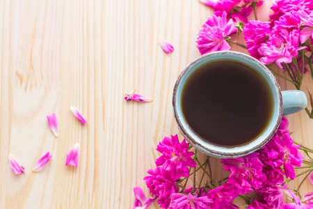 Napoleon cake, cup of coffee and pink garden roses on wooden tableの写真素材