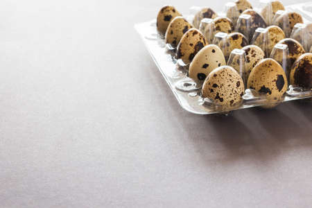 Quail eggs in a clay bowl on dark stone table. Close-upの写真素材