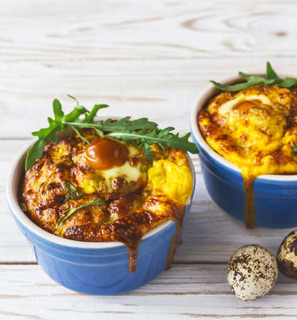 Italian cauliflower with quail eggs, arugula and spices in baking dishes on the table. ?lose up.の写真素材