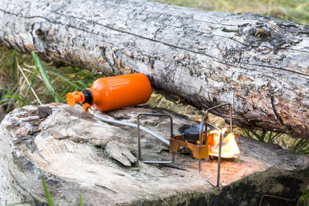 portable gas burner on the wooden logs.の写真素材