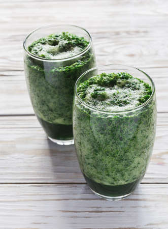 Healthy green sorrel and spinach smoothie in glass jar with wooden background.の写真素材