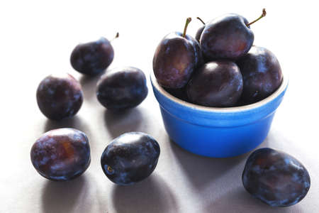 Sweet ripe plums on rustic background.