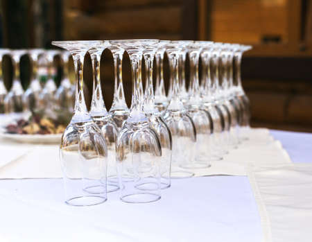The line of empty stemware at the table in restaurant. Close up.の写真素材