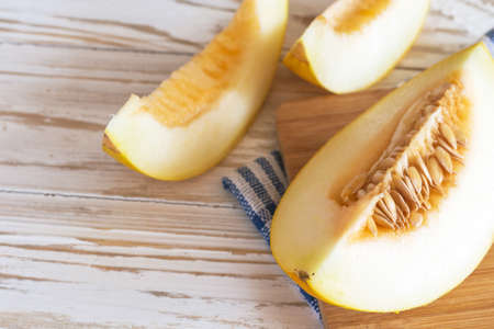 Fresh melons sliced on wooden tableの写真素材