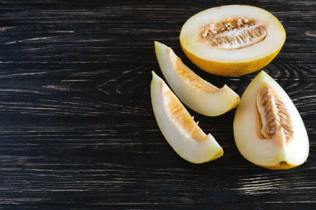 Fresh melons sliced on wooden table