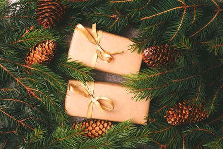 Christmas Craft gift boxes and decoration - Christmas tree branches and cones on slate marble. Flat lay, copy space, top view.の写真素材