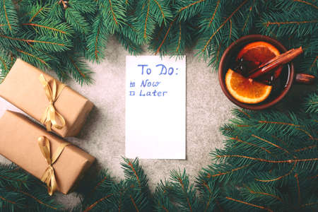 Hot mulled wine with spices, Christmas tree, gifts and cones on marble background. To do list. Planning and design concept
Flat lay, copy space, top view.の写真素材