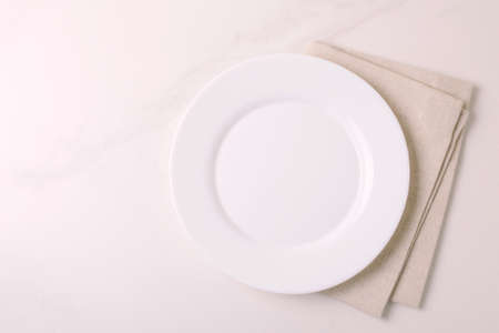 Food background. White empty plate, napkin on stone gray background. Top view, flatlay, copyspace.の写真素材