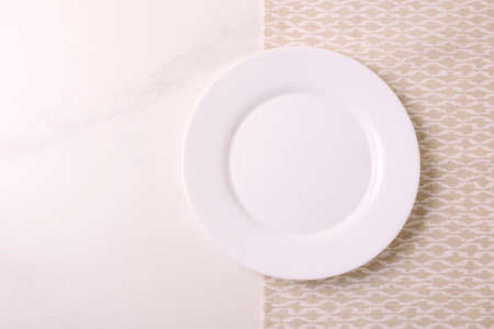 Food background. White empty plate, napkin on stone gray background. Top view, flatlay, copyspace.の写真素材