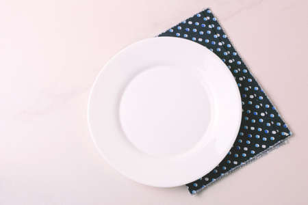Food background. White empty plate, napkin on stone gray background. Top view, flatlay, copyspace.の写真素材