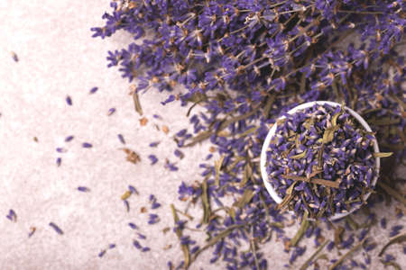 Dry lavender flowers on gray stone background. Top viewの写真素材