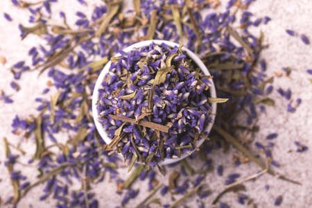 Dry lavender flowers on gray stone background. Top viewの写真素材