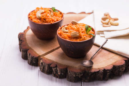 Traditional Indian cuisine. Homemade carrot Gajar halwa on wooden background. Copyspace, horizontal viewの写真素材