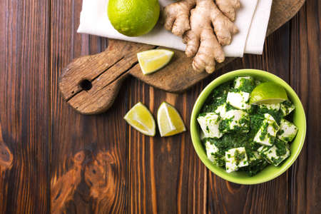 Traditional Indian cuisine. Homemade palak paneer on wooden background. Copyspace, top view