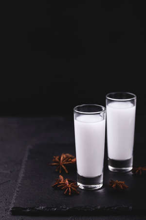 Arabic alcohol drink Raki with anis on slate black background.Turkish and Greek Traditional aperitif arak, Ouzoの写真素材
