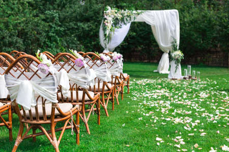 Beautiful setting for outdoors wedding ceremony waiting for bride and groom and guests. Decorationの写真素材