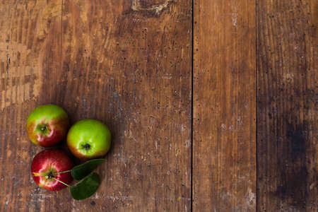 Red ripe apples at dark wooden table. Harvest concept. Copyspaceの写真素材