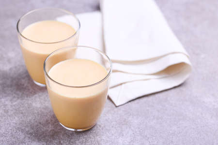 Traditional Indian cuisine. Turmeric milk with cinnamon, saffron, cardamom and turmeric on gray slate background. Copyspace, horizontal view, flatlayの写真素材