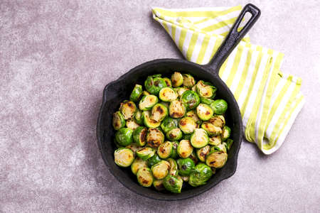 Vegetarian cuisine. Homemade Brussels Sprouts roasted with olive oil on gray slate background. Copyspace, top view, flatlay.の写真素材