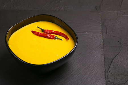 Traditional Indian cuisine. Vegetarian curry Gujarati Kadhi with chickpea gravy and sour yogurt. Copyspace, horizontal view, flatlayの写真素材