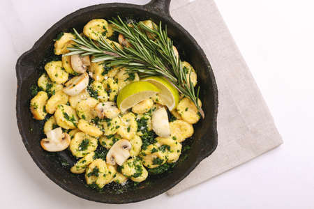 Traditional Italian cuisine. Gnocchi with a cream sauce, olives and rosemary on white background. Copyspace, top viewの写真素材