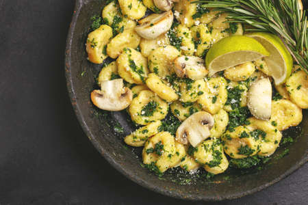 Traditional Italian cuisine. Gnocchi with a cream sauce, olives and rosemary on white background. Copyspace, top viewの写真素材