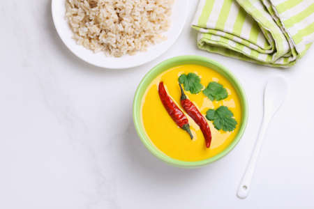 Traditional Indian cuisine. Vegetarian curry Gujarati Kadhi with chickpea gravy and sour yogurt. Copyspace, top view, flatlayの写真素材