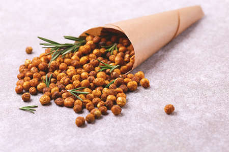 Traditional Indian cuisine. Roasted spicy chickpeas with lime and rosemary on gray slate background. Copyspace, horizontal view.の写真素材