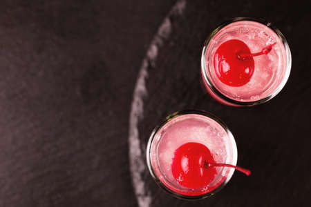 Alcoholic shot cocktail sour cherry gin or porch crawler with liqueur and lime. Black background. Top view. Copy spaceの写真素材