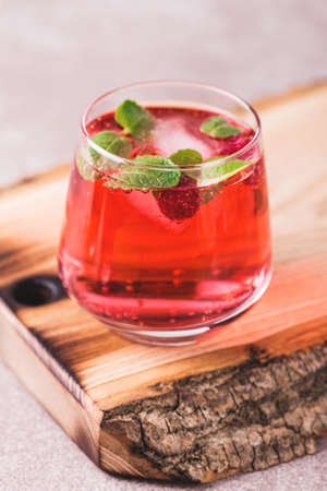 Aperitif with  mint and raspberry, selective focus. Iced lemonade