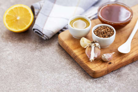 Ingredients for homemade sweet and sour sauce on the wooden slice board background. Horizontal view. Copyspaceの写真素材