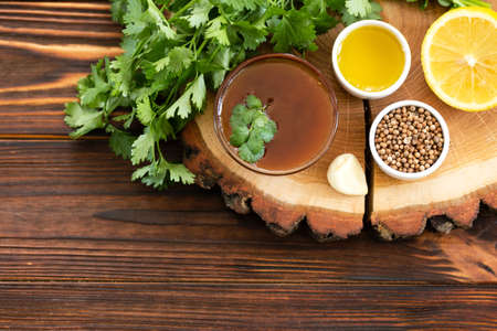 Ingredients for homemade sweet and sour sauce with lemon, honey and herbs on the wooden background. Top view. Copyspaceの写真素材