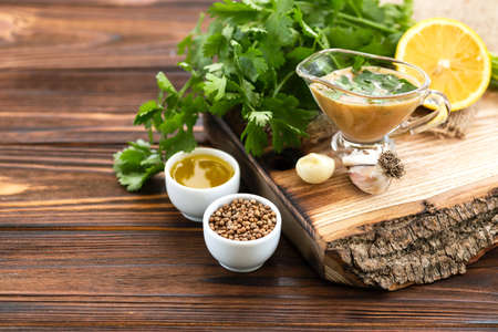 Sweet and sour sauce with ingredients on the wooden background. Horizontal view. Copyspaceの写真素材