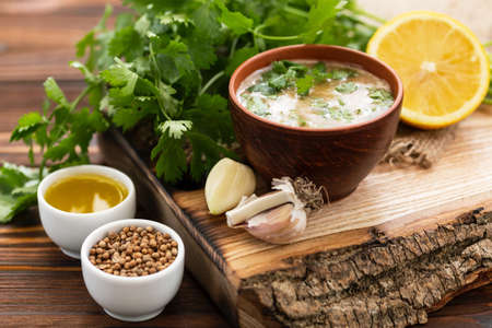 Sweet and sour sauce with ingredients on the wooden background. Horizontal view. Close upの写真素材