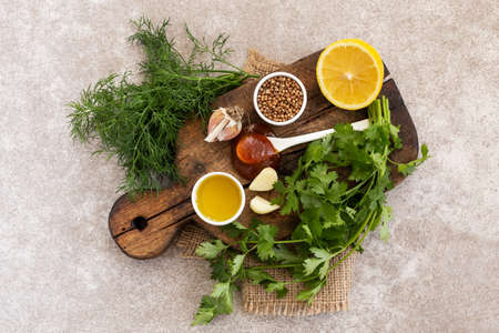 Ingredients for homemade sweet and sour sauce with lemon, honey and herbs on the wooden background. Top view. Copyspaceの写真素材