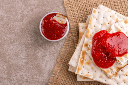 Traditional Jewish kosher matzo with jam  on rustic burlap napkin. Copy space. Top viewの写真素材