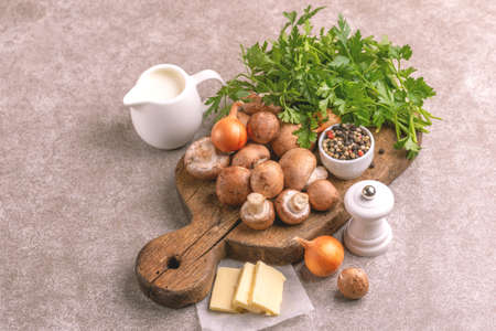 Fresh ingredients for tasty pureed mushroom soup. Healthy food concept. Gray marble background. Horizontal view. Copy spaceの写真素材