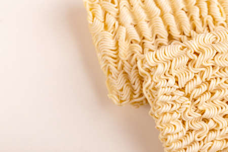 Uncooked instant noodles on white marble background. Copy space.の写真素材