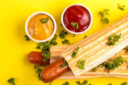 Two grilled french hot dogs with mustard and ketchup on bright background. Junk or fast food. Copy spaceの写真素材