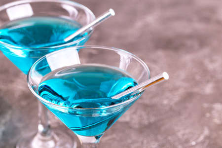 Two glasses of trendy blue wine with paper straws. Spanish blue wine chardonnay on dark concrete background. Romantic dateの写真素材